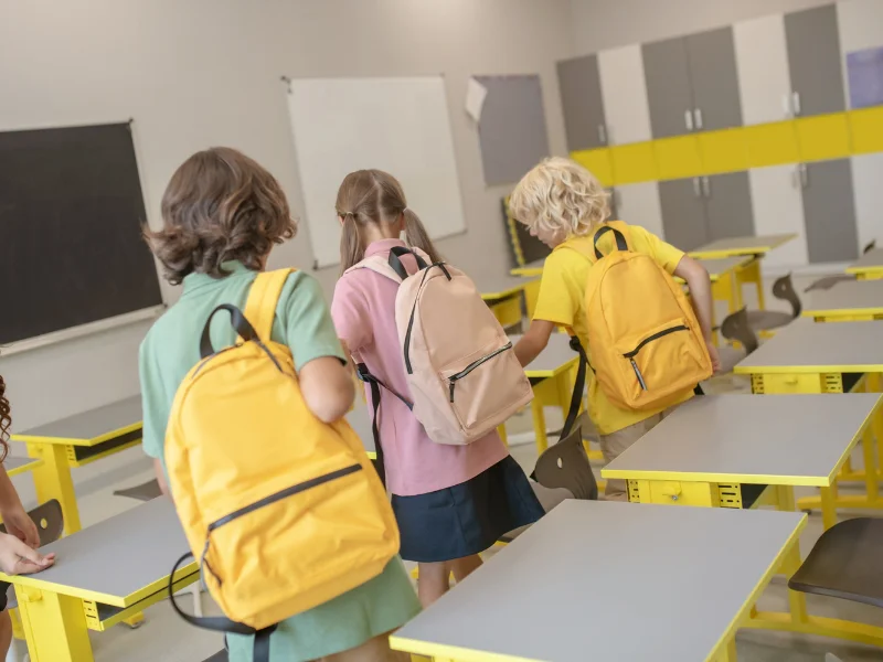Alumnos con mochilas en un centro escolar en el inicio del curso en Cataluña
