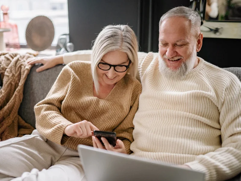 Pareja de pensionistas consultando un informe económico en un entorno digital
