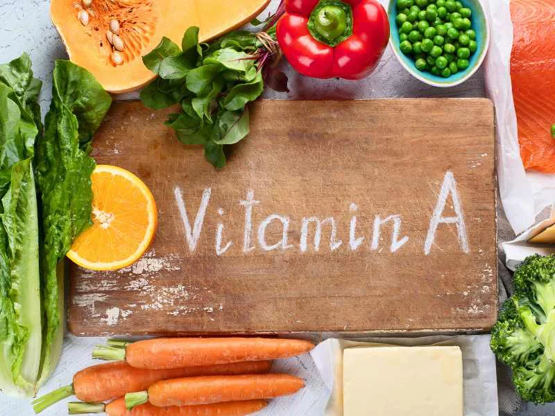 Alimentos ricos en vitamina A y antioxidantes como zanahorias, espinacas, naranjas y huevos